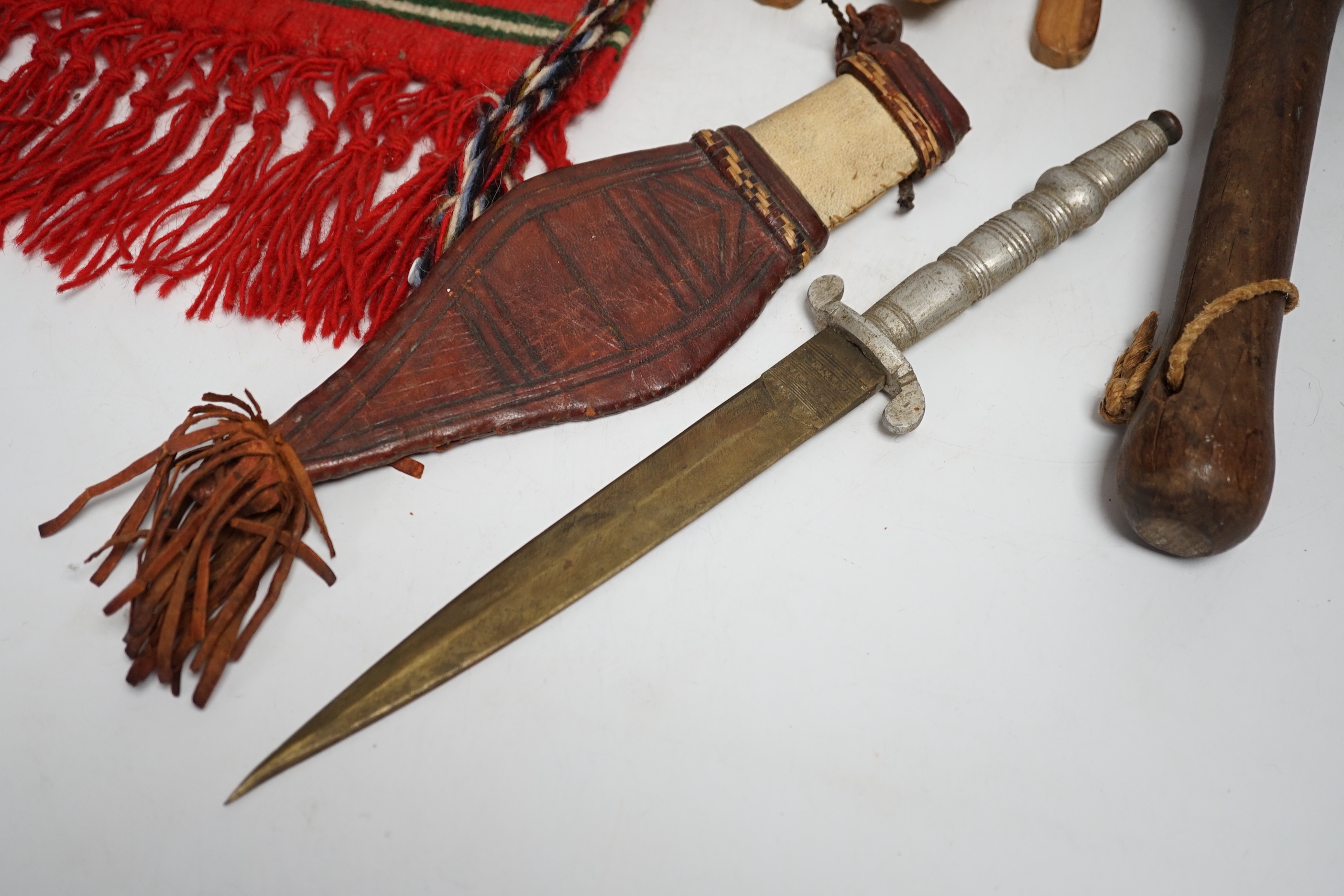 A kukri, a long dagger and sheath, a mace, and two African ebony busts